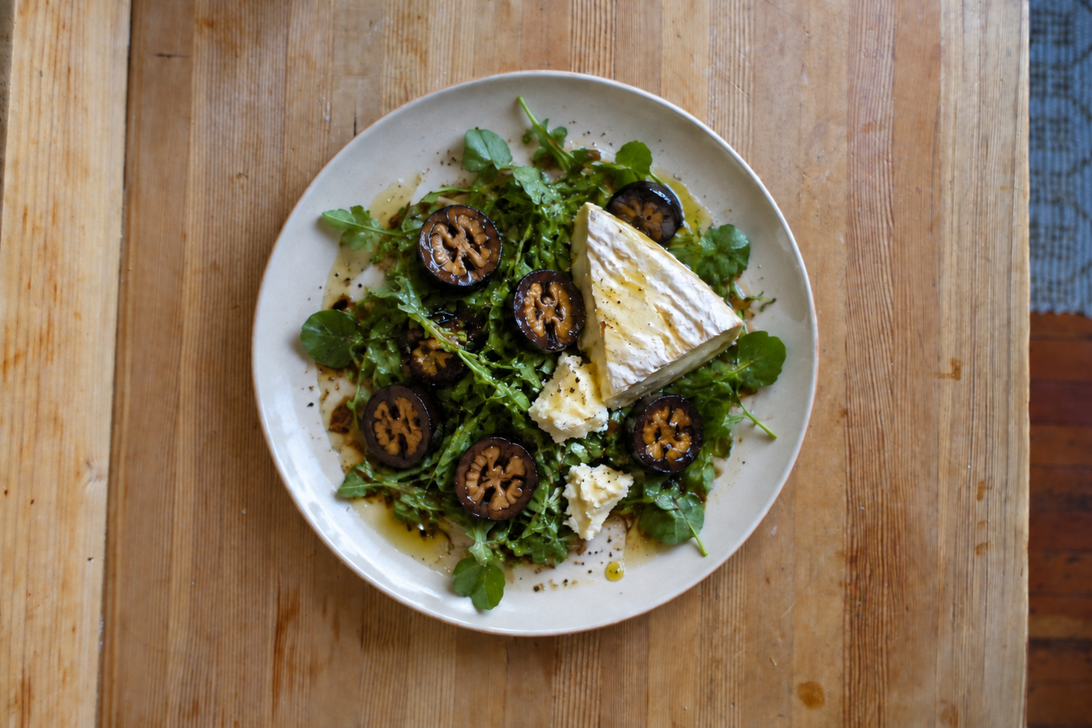 Pickled walnuts with soft cheese on greens