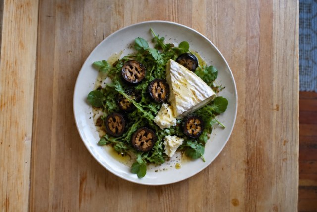 Pickled walnuts with soft cheese on greens